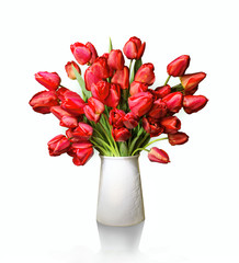 Bouquet of red tulips in white vase