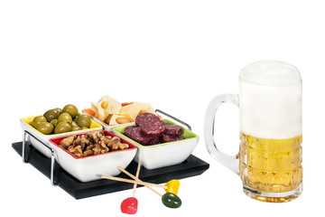 mug of beer with cheese, olives , salami and nuts