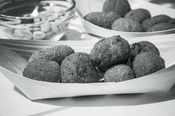 Breaded appetizer aperitif in saucer. bw photo.