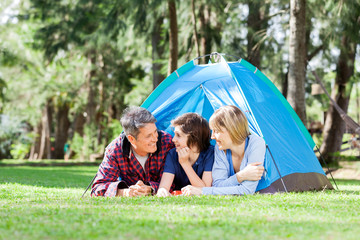 Family Relaxing Inside Tent