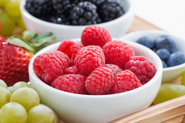 fresh raspberry close-up and an assortment of berries