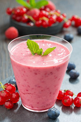 refreshing milkshake with fresh berries and mint in glass