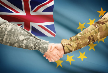 Men in uniform shaking hands with flag on background - Tuvalu