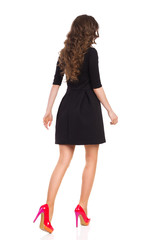 Walking Woman in Black Mini Dress, Rear View