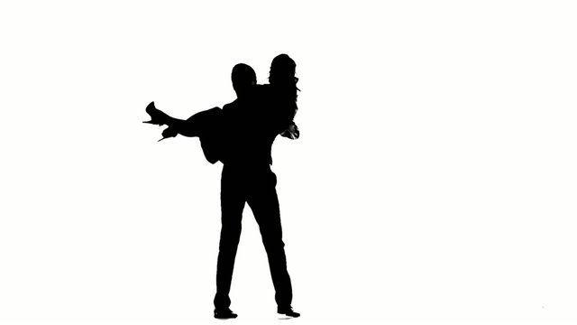 couple man and woman walking hand in hand. Silhouette. Slow