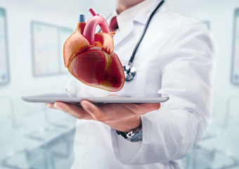 Doctor with stethoscope in a hospital. Heart on the tablet