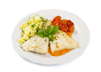 white dish of Fresh black cod with potatoes and tomatoes sauce