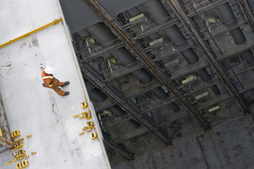man working over precipice - risk of falling 
