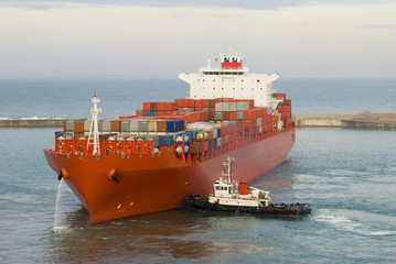 container vessel and a small tugs pushing