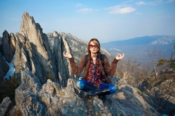 Woman meditating at the mountain top