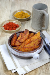 Roast potatoes with spices and ceramic beer mug