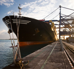 Cargo ship in the harbor at sunset Mauritius