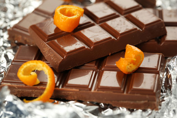 Chocolate with orange peels in foil, closeup