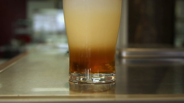 Beer is poured in a glass.