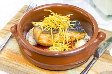 Baked salmon fillet with vegetables in a restaurant