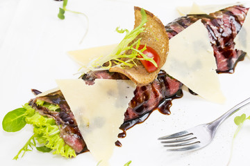 carpaccio with herbs and cheese on white background