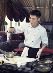 Japanese chef preparing a meal in a restaurant