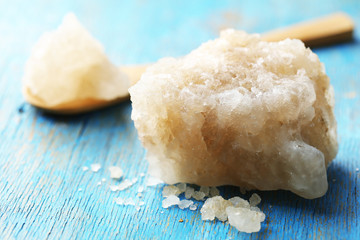 Crust of sea salt from Dead Sea coast, on color wooden background