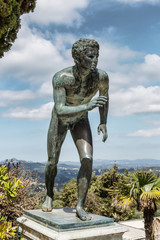 Fototapeta na wymiar A statue of 'The Runner' in the garden of Achilleion