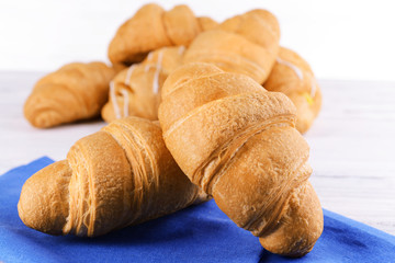 Delicious croissants on table close-up