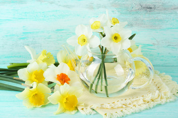 Fresh narcissus flowers on wooden background
