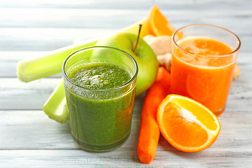 Assortment of healthy fresh juices on wooden table background