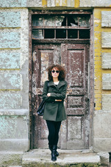 Fototapeta na wymiar Stylish young woman in sunglasses posing outdoor. Full length po