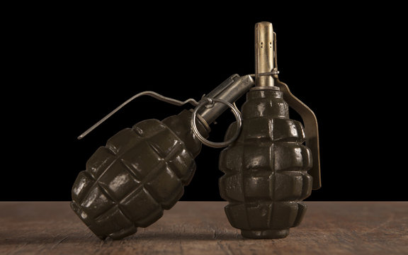 two hand grenade on wooden table