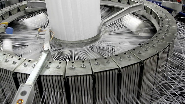 Textile industry - yarn spools on spinning machine in a factory