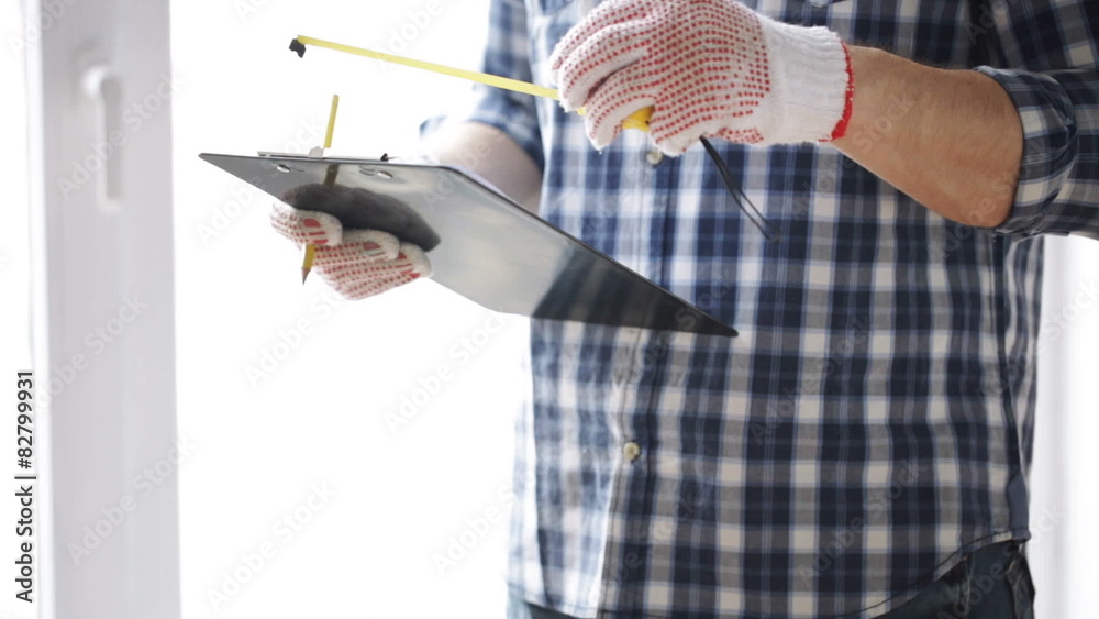 Wall mural close up of man with measuring ruler and clipboard