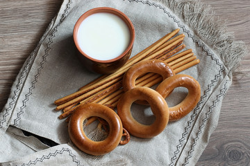 food milk in a glass straw bagels and pretzels