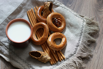 food milk in a glass straw bagels and pretzels