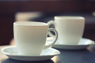 White cups on a plates on the table