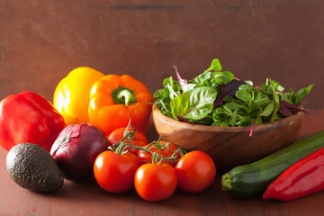 healthy vegetables pepper tomato salad onion avocado on rustic b