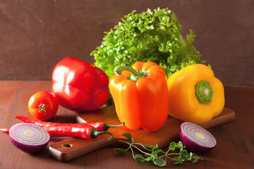 healthy vegetables pepper tomato salad onion chilli on rustic ba