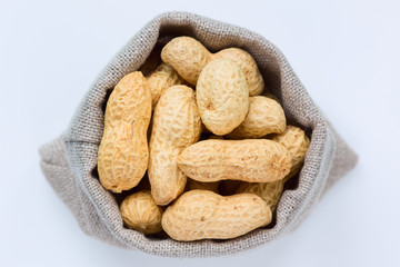 Isolated peanuts (groundnuts) in the linen bag
