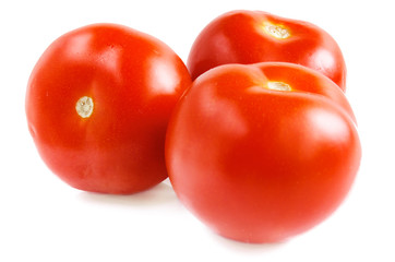 Three ripe tomatoes on a white background.