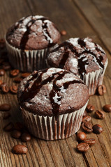 Cupcake with chocolate on wooden background
