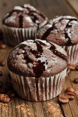 Cupcake with chocolate on wooden background