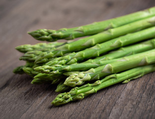fresh green asparagus on wooden background