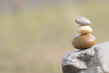 Fototapeta na wymiar three stones standing on one another symbolize balance