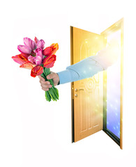 Hand sends a bouquet of tulips in the open door. isolated