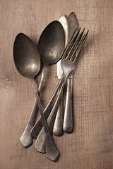 vintage silver cutlery fork spoon on wooden backdrop ...