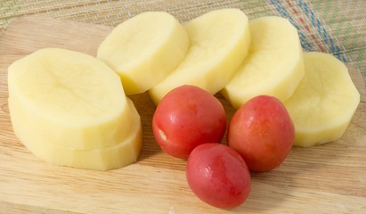 Fresh Tomatoes and Potatoes on A Wooden Board