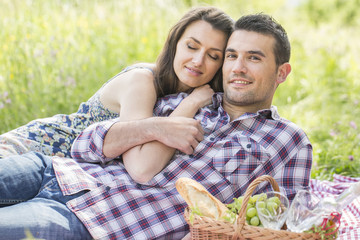 happy couple having a picnic in summer