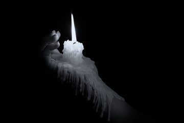 Open hand holding candle stick with wax flowing down the arm art