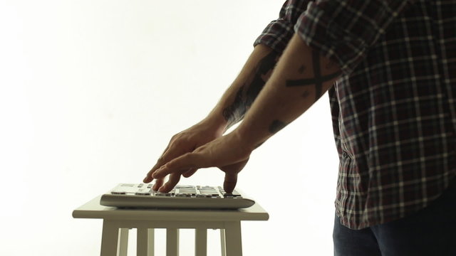Man DJ masterly playing on an electric music controller