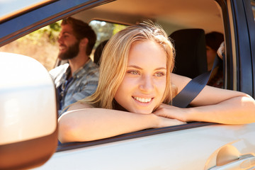 Group Of Friends In Car On Road Trip Together