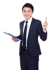 Asian businessman hold with clipboard and pen point up