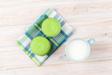 Colorful macarons and cup of milk
